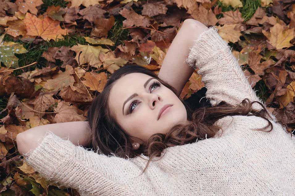 woman laying on leaves